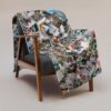 Personalized photo collage blanket with custom pictures on chair sofa Personalized photo collage blanket with custom pictures displayed on chair sofa in modern grey space.